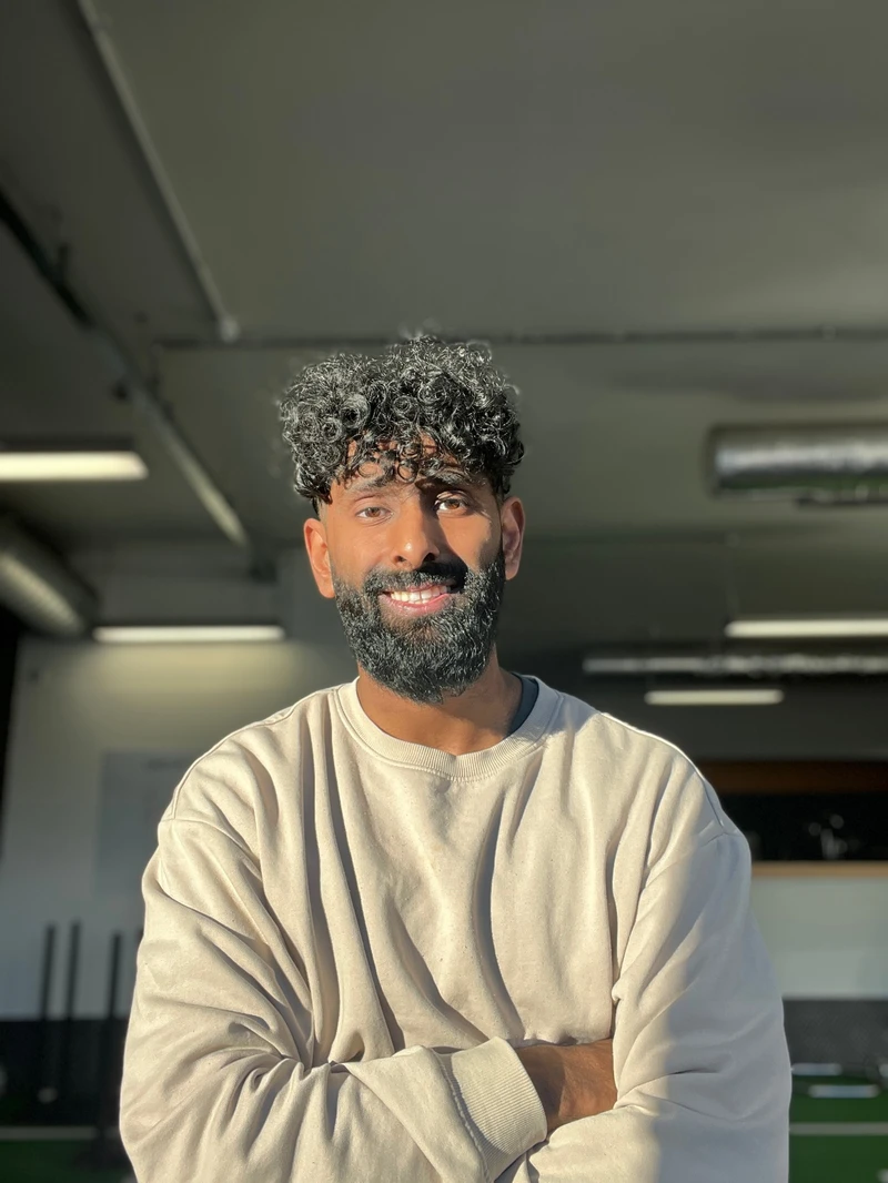 Coach Muhammad smiling inside the gym